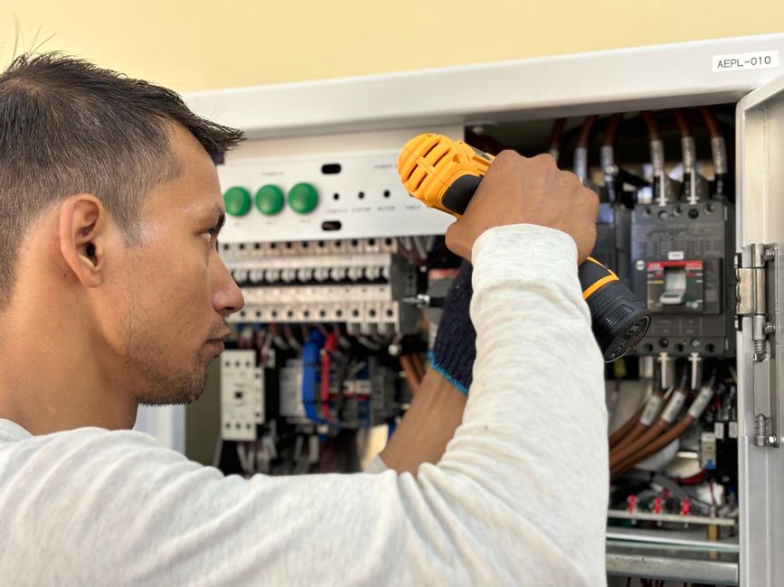 Electrician wiring a circuit panel on a service call